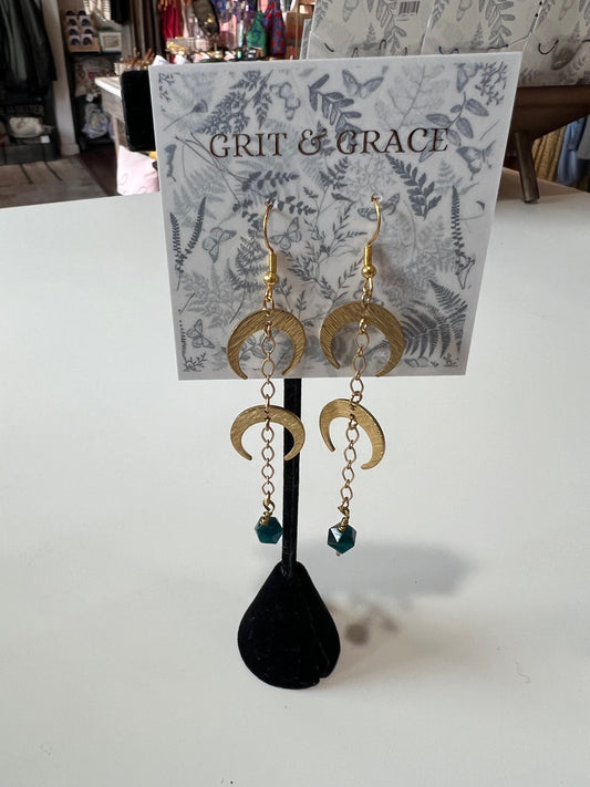 brass dangle crescent moon earrings with two crescent moons and a blue tiger eye stone drop