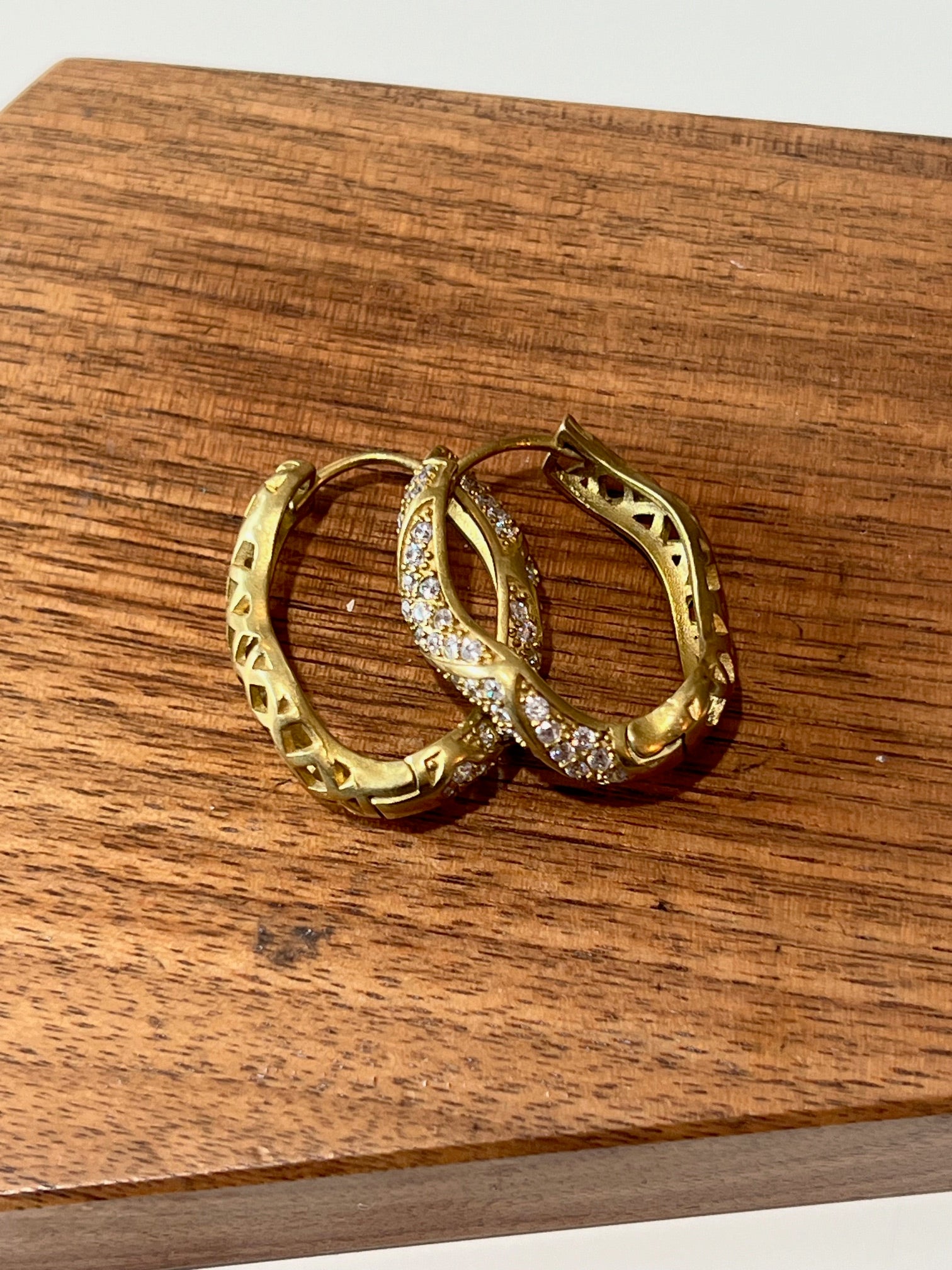 medium sized wavy huggie brass earrings with rhinestines